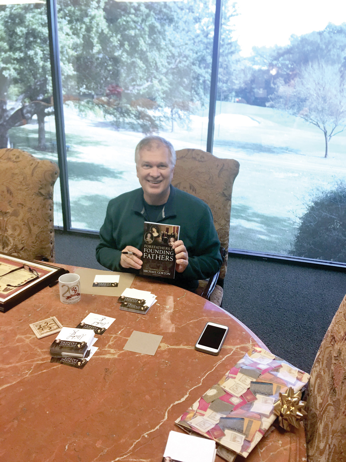 WRITING HIS OWN HISTORY: Michael Gorton, a direct descendant of Samuel Gorton, holds his finished book, a conversational, historically accurate account of Gorton’s life, and how it led to the foundation of American democracy.